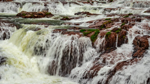 istock waterfall with red rock and green lush forest flat angle shot 1266584041