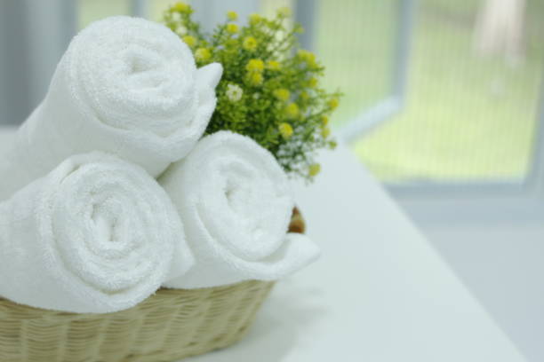 istock Roll up white towels in the basket on the table. 1266585152