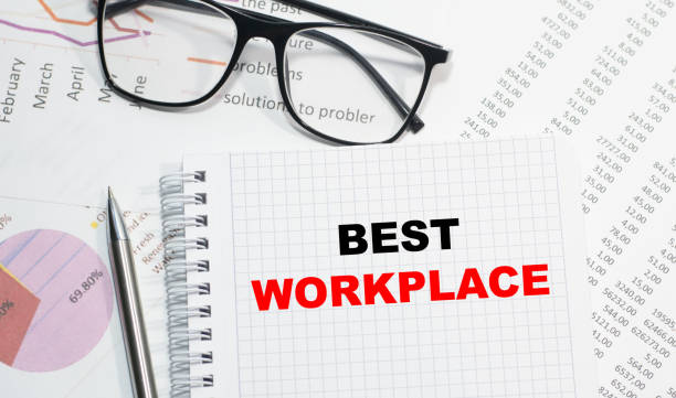 istock Business concept. Notebook with text BEST WORKPLACE sheet of white paper for notes, calculator, glasses, pencil, pen, in the white background 1266585153