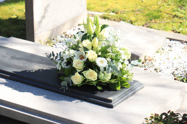istock Funeral flowers on a tomb 1266586247