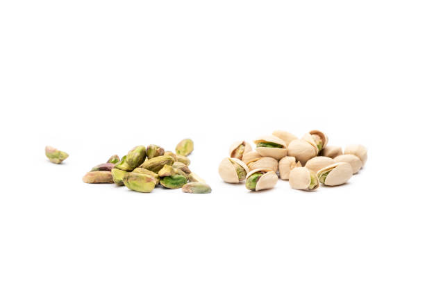 istock Two groups of pistachios with white background 1266587141