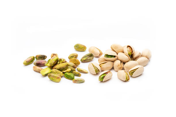 istock Two groups of pistachios with white background 1266587146