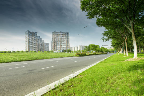 istock Clear sky, urban buildings, roads by dense woods 1266587191