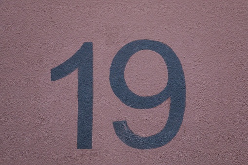 A closeup shot of the number sign of a house
