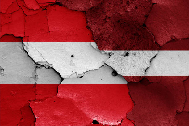 istock flags of Austria and Latvia painted on cracked wall 1266589884