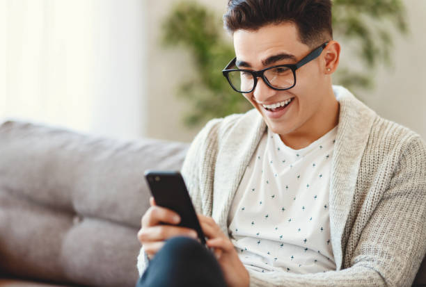 istock Shocked cheerful guy reading message on smartphone 1266589979