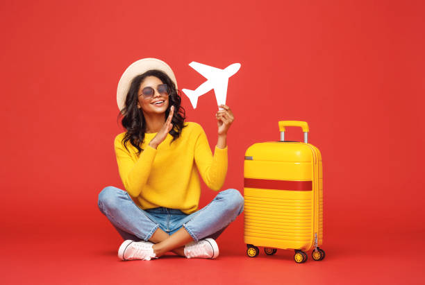 Ethnic traveler playing with toy plane