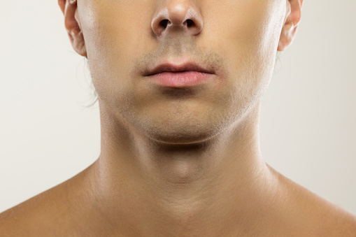 Men skin care and beauty. Closeup of clean-shaven male face.
