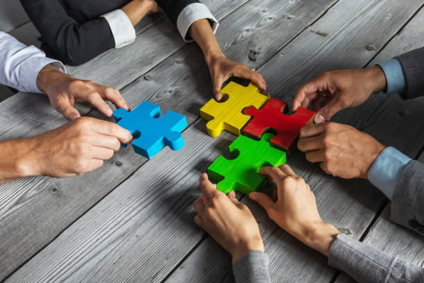istock Business people and puzzle pieces 1266590864