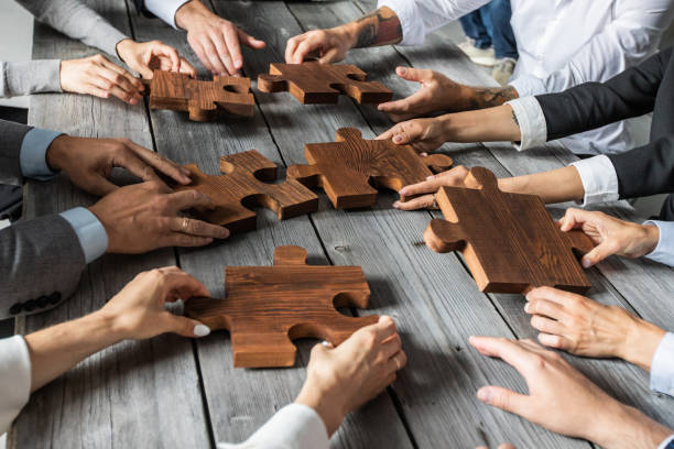 istock Business people and puzzle pieces 1266590875