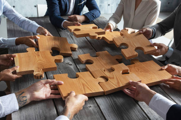 istock Business people and puzzle pieces 1266590878