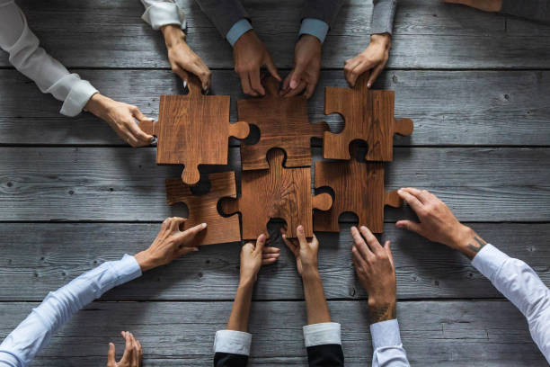 istock Business people and puzzle pieces 1266590880