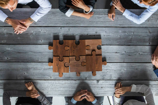 istock Business people and puzzle pieces 1266590890