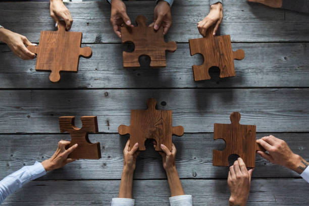 istock Business people and puzzle pieces 1266590901