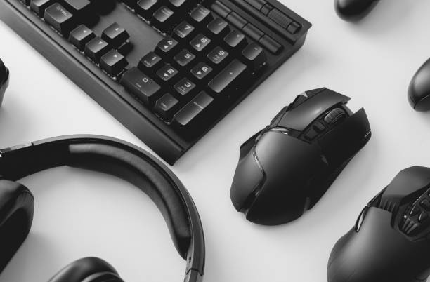 istock gamer work space concept, top view a gaming gear, mouse, keyboard, joystick, headset, mobile joystick, in ear headphone and mouse pad on black table background. 1266591467