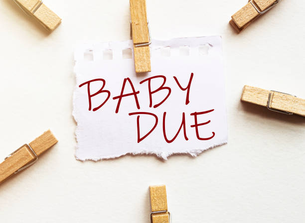 istock white paper with text Baby Due with clothespins on white background 1266592317