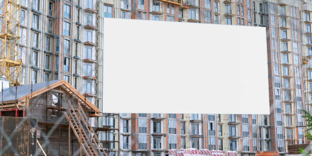 istock white empty sign board on facade of modern unifinished house with mock-up 1266593510