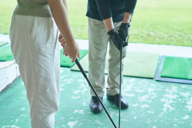 istock Men and women taught golf at the golf course 1266593678