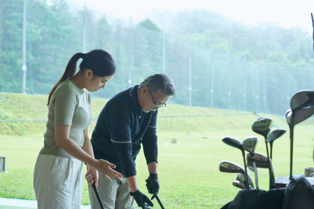 istock Men and women taught golf at the golf course 1266593702