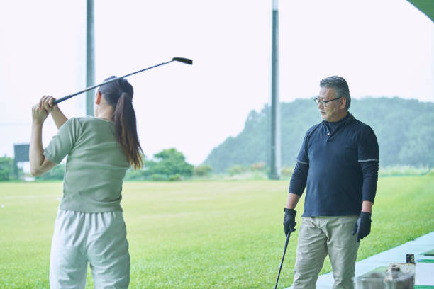 istock Men and women taught golf at the golf course 1266593728