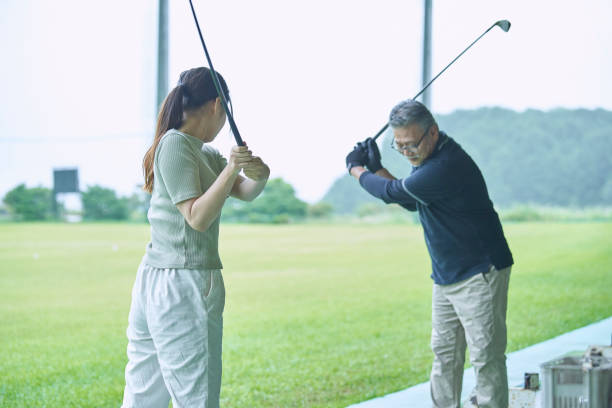 istock Men and women taught golf at the golf course 1266593729
