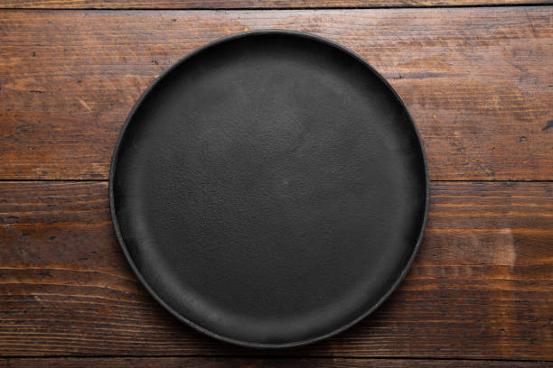 istock Cast iron frying pan on wood background, top view. 1266593897
