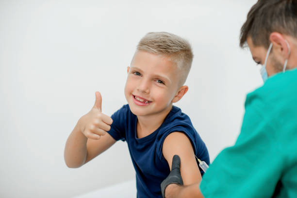 istock Pediatrician makes vaccination to cute schoolboy 1266595057