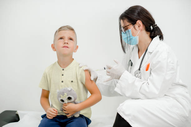 istock Pediatrician makes vaccination to cute schoolboy 1266595618