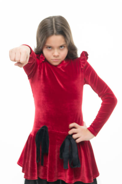 Strong temper. Threatening with physical attack. Kids aggression concept. Aggressive girl threatening to beat you. Dangerous girl. Feel my power. Girl kid threatening with fist isolated on white.