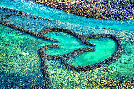Twin Hearts Stone Tidal Weir in Chimei island, Landmark of the Penghu Islands