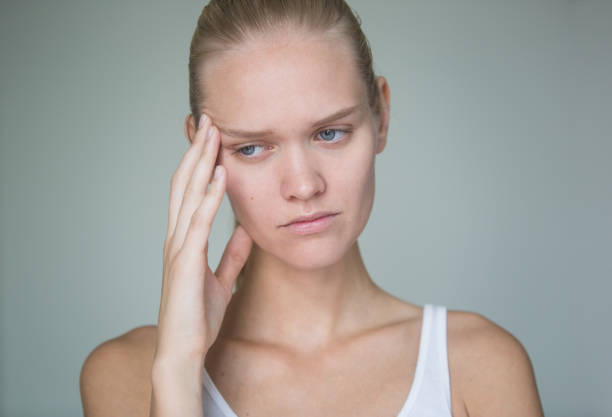 Close-up view of young crying woman's face on black