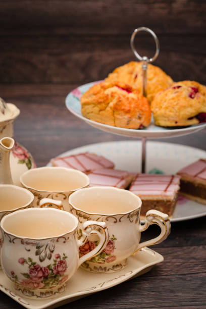 istock Porcelain tea cups and cakes on the stand 1266607182