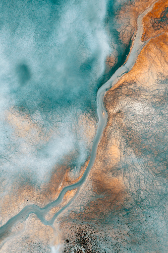 Aerial view of beautiful natural shapes and textures on lake which looks like an abstract painting. Taken via drone.