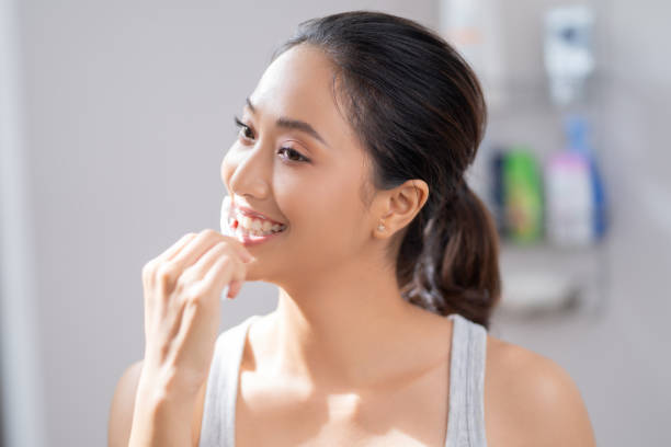 istock Beautiful female brushing teeth in the bathroom 1266612660