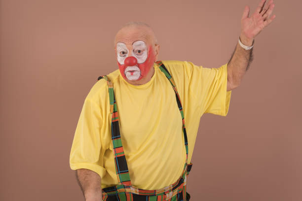 istock Old-aged clown on brown background 1266613548