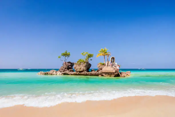 Willys Rock is a tidal island with a statue of the Virgin Mary at the Boracay beach in Philippines