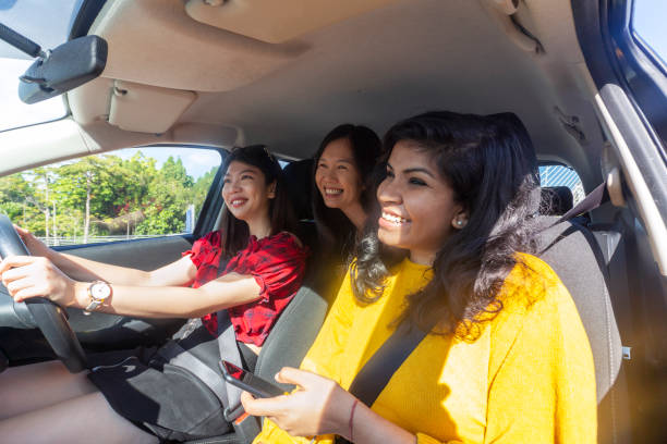 istock Three women enjoying car ride, going holiday 1266616487