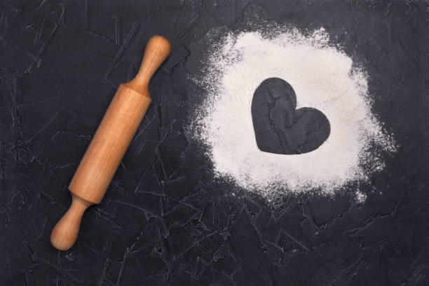 istock Scattered flour on the table and rolling pin. View from above. A heart. 1266616681