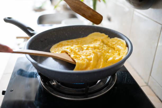 istock fried omelet in hot pan on strove 1266618670
