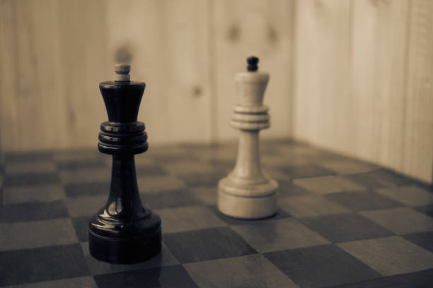 istock Playing chess. Player taking right action and making checkmate. Concept of running company and leading business 1266619367