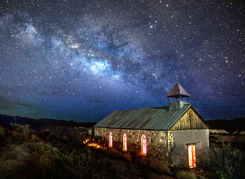 Predawn in Terlingua, TX the Milky Way rises to the SE. This rarely used church in the ghost town was a perfect subject. I put 3 headlamps on the pews to light the windows and light painted the exterior.