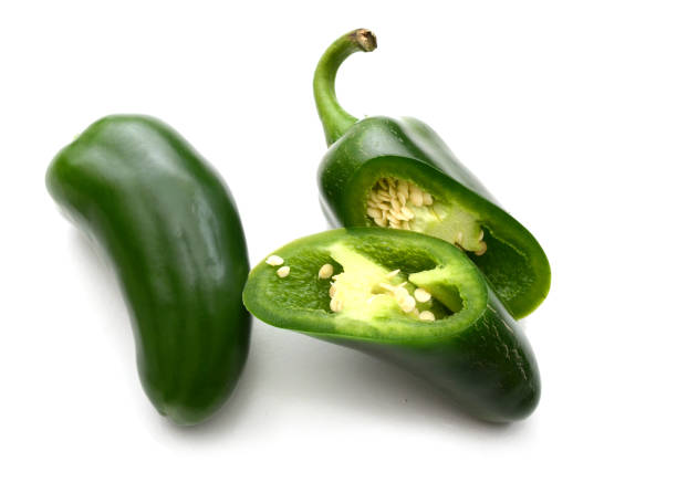 istock Green jalapeno chili peppers with half on white with clipping path 1266620320