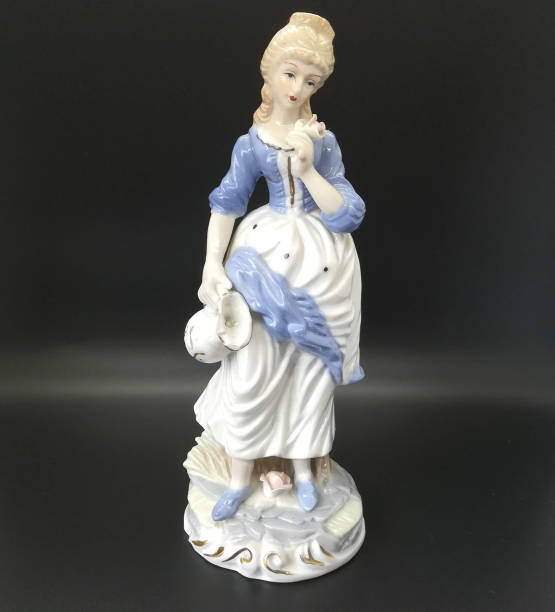 istock Ceramic figures of people on black background 1266620895