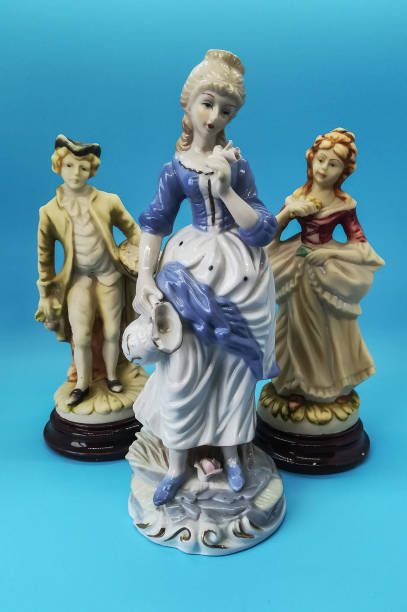 istock Ceramic figures of people on blue background 1266621016