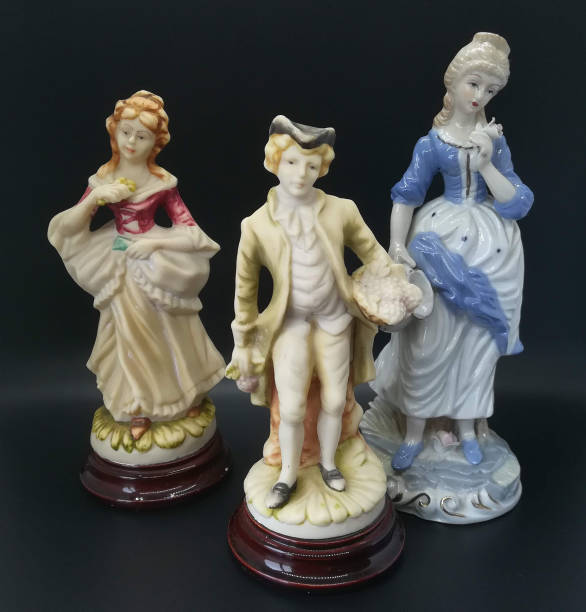 istock Ceramic figures of people on black background 1266622575