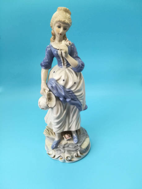 istock Ceramic figures of people on blue background 1266622688