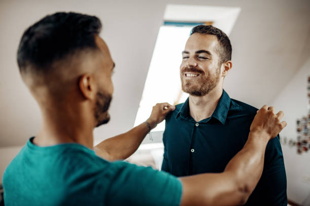 istock LGBT couple at home dressing up 1266622969