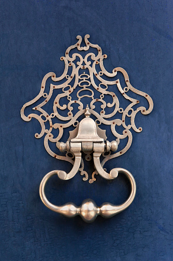 Close up of a stylish bronze door knocker of a French house