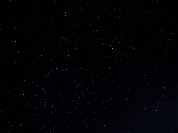 istock Dark background of stars in long exposure 1266626113