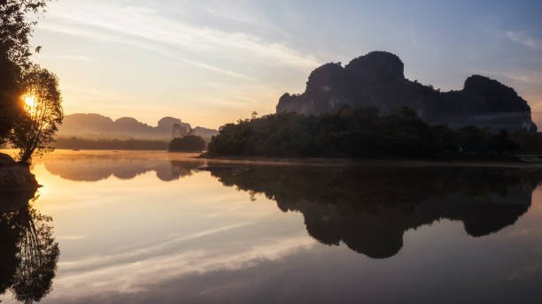 istock sunrise view reflection nature mountain on lake 1266626442